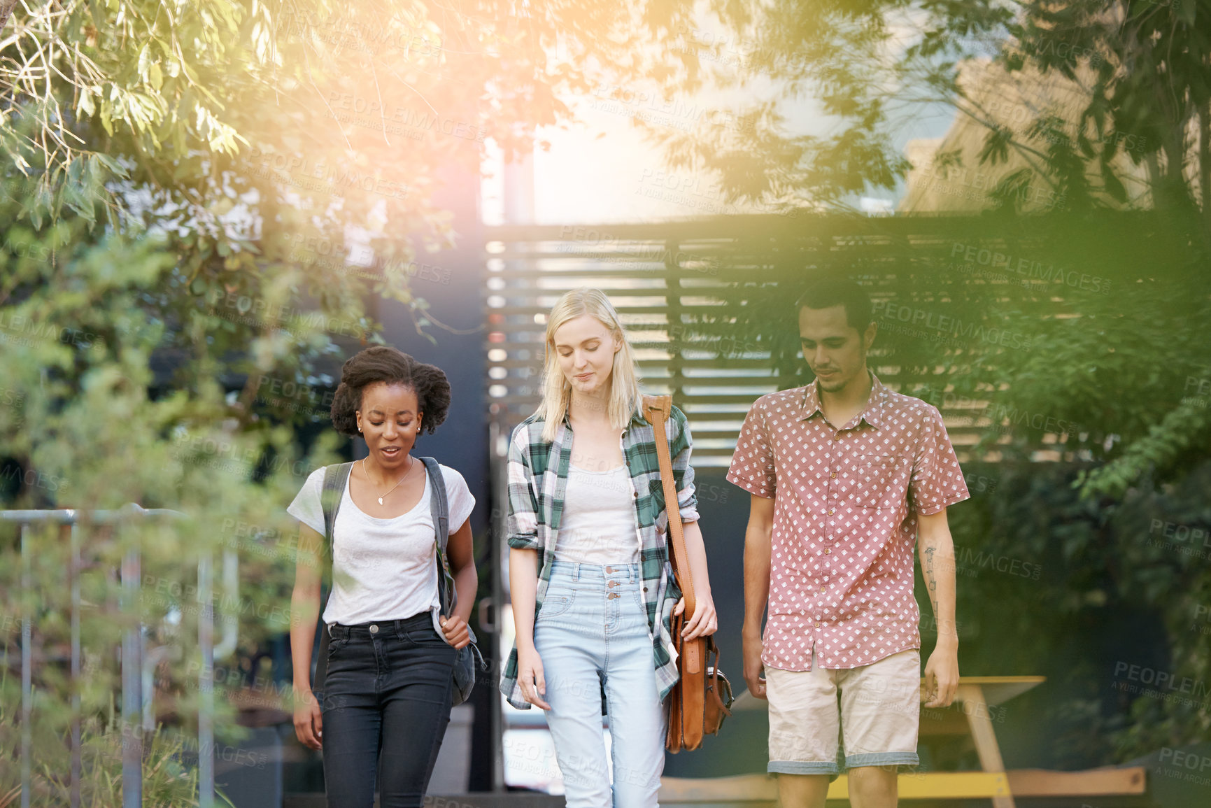 Buy stock photo Walking, conversation and young students at university planning for study, assignment or test. Networking, discussion and diversity friends with bags bonding and talking at college campus together.