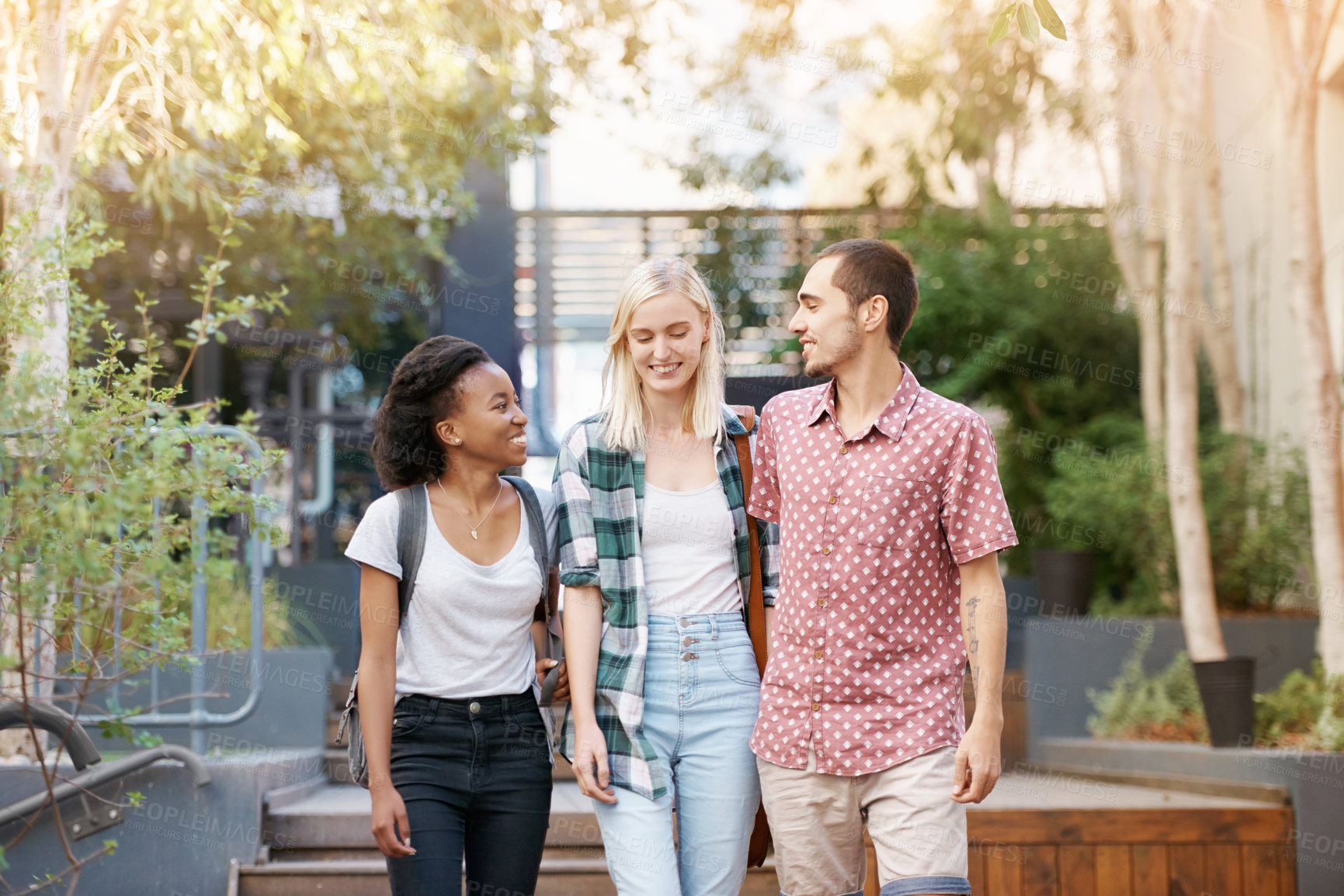 Buy stock photo Walking, education and young students at university planning for study, assignment or test. Scholarship, conversation and young people with bags bonding and talking at college campus together.