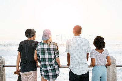 Buy stock photo Sunshine, fashion and back of friends by ocean for holiday, summer vacation and weekend outdoors. Diversity, promenade and men and women by sea for travel, adventure and relax together for bonding