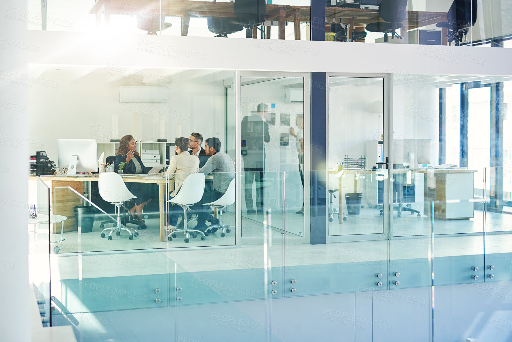 Buy stock photo Shot of corporate colleagues working together in their office