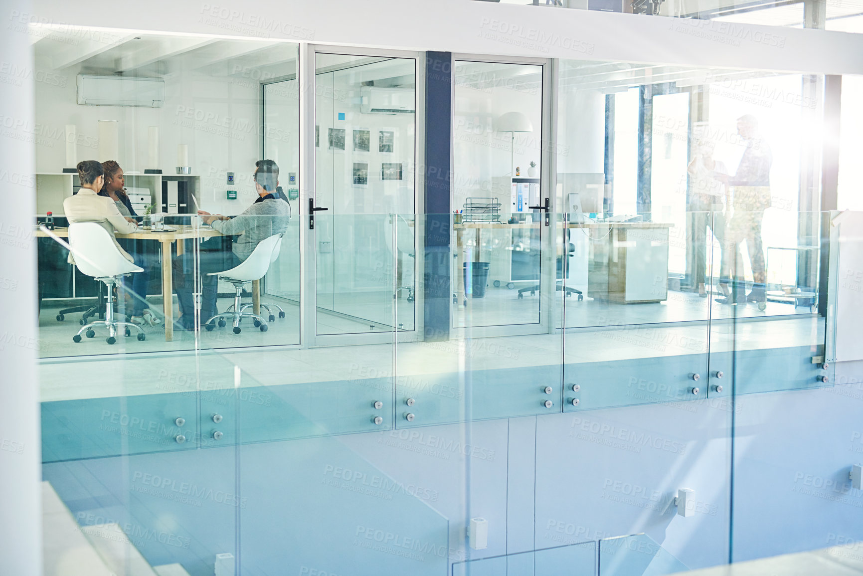 Buy stock photo Shot of corporate colleagues working together in their office