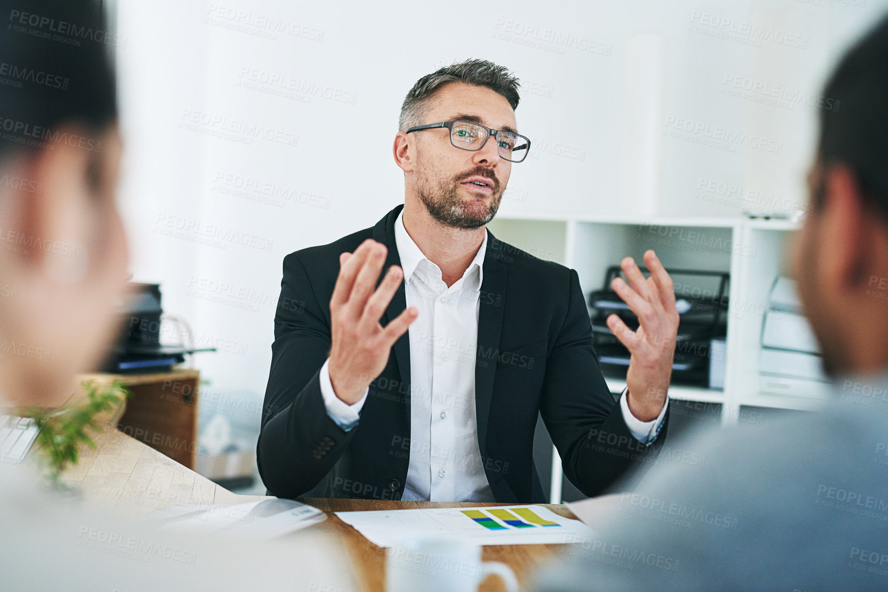 Buy stock photo Shot of corporate colleagues working together in their office