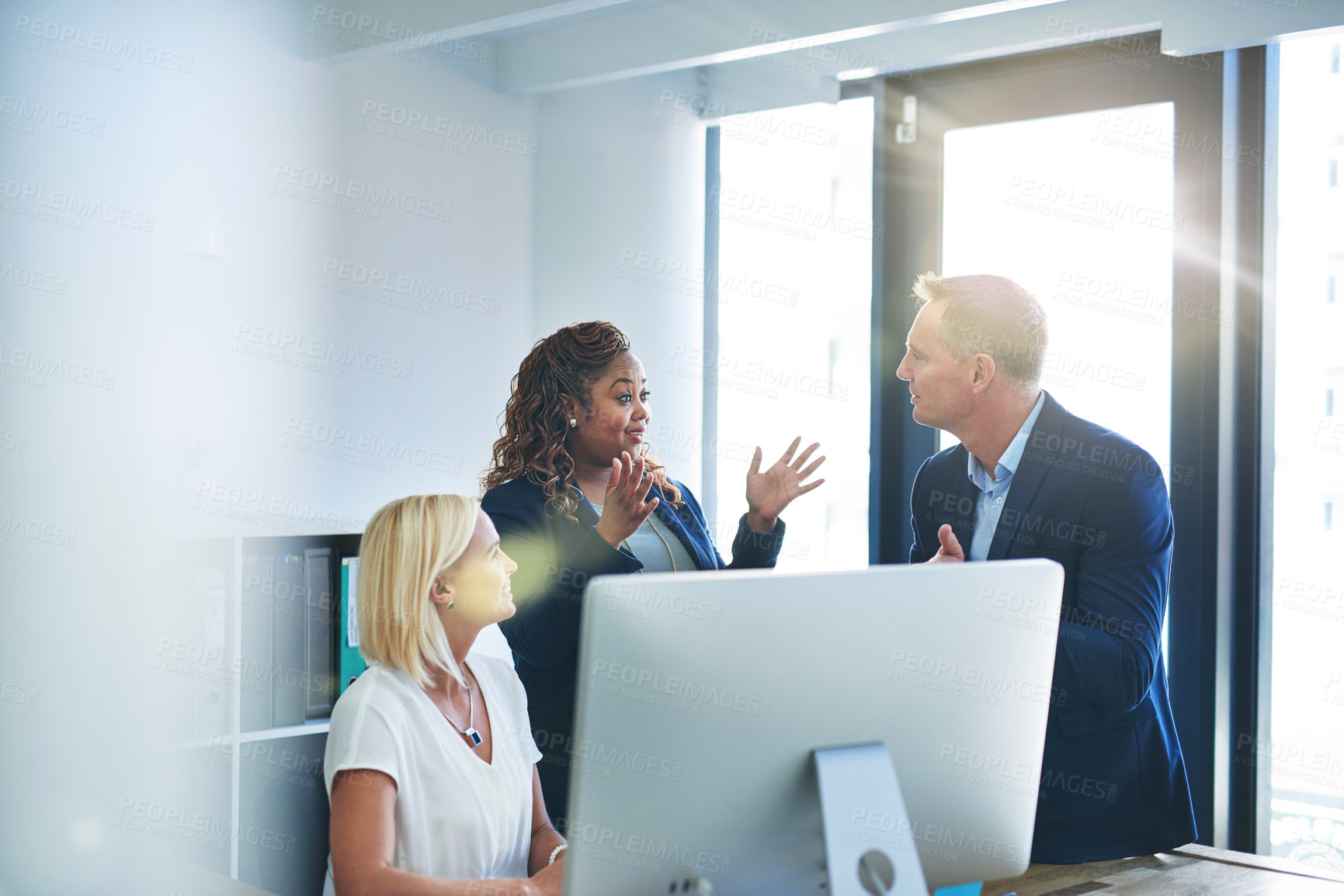 Buy stock photo Shot of corporate colleagues working together in their office