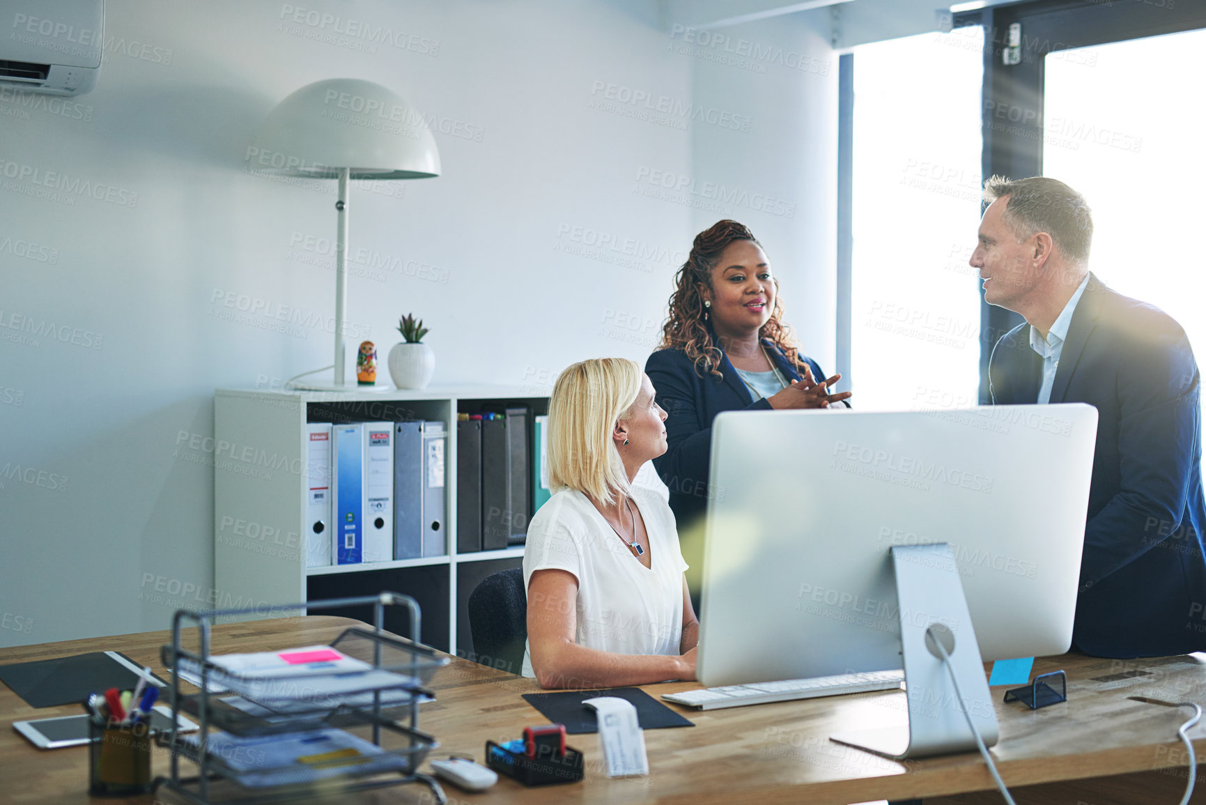 Buy stock photo Shot of corporate colleagues working together in their office