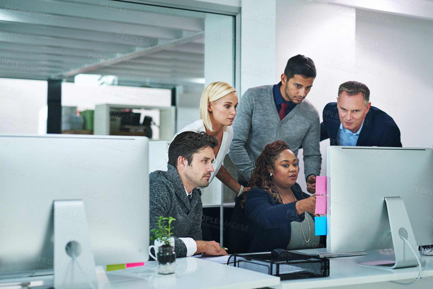 Buy stock photo Shot of corporate colleagues working together in their office