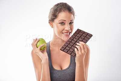 Buy stock photo Woman, chocolate and apple with comparison for diet, weight loss and balance with snacks on white background. Nutrition, fruit and candy with unhealthy versus healthy food, benefits and wellbeing