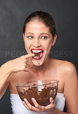 Buy stock photo Woman, chocolate and happiness in studio for cosmetics, baking and sugar for comedy. Candy, pride and cocoa on backdrop for wellness, humour and nutrition isolated on dark background for diet.