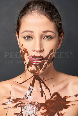 Buy stock photo Woman, licking lips and chocolate on body for temptation, sweet craving and messy paint. Young person with guilty facial expression and isolated for candy, brown sauce and sugar for delicious tasty