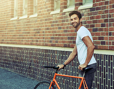 Buy stock photo Smile, bicycle and portrait of man by brick wall in city for sightseeing on vacation or adventure. Happy, walking and male person with bike in town street on weekend trip or holiday in Netherlands.