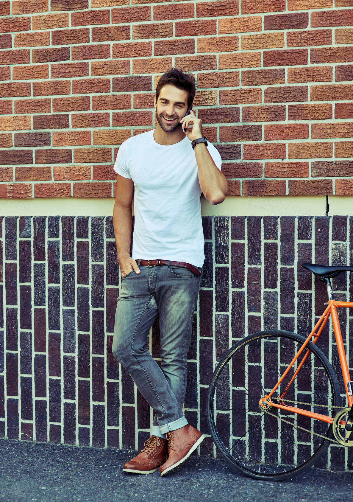 Buy stock photo Shot of a young handsome man spending the day in the city 