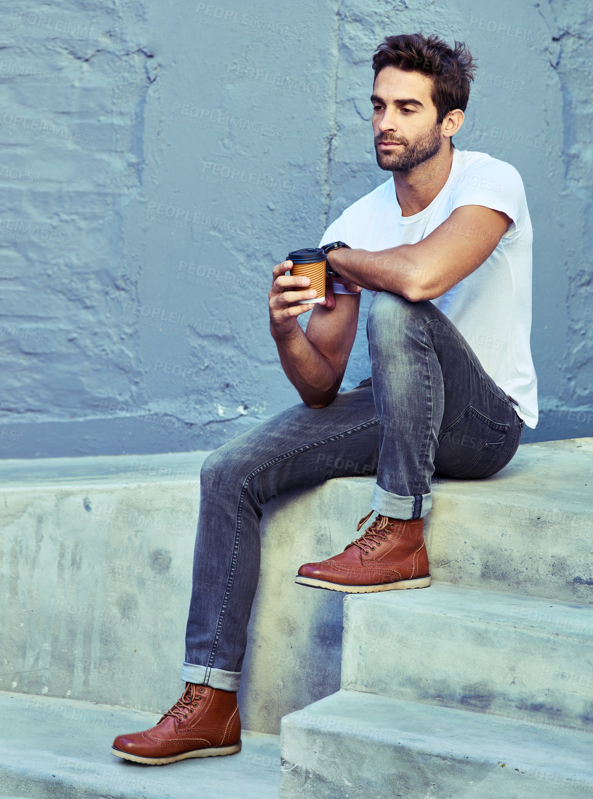 Buy stock photo Shot of a young handsome man spending the day in the city 