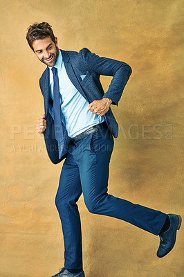 Buy stock photo Corporate, fashion and business man running in studio on yellow background for job opportunity. Development, growth and progress with happy young employee in suit for start of new professional career