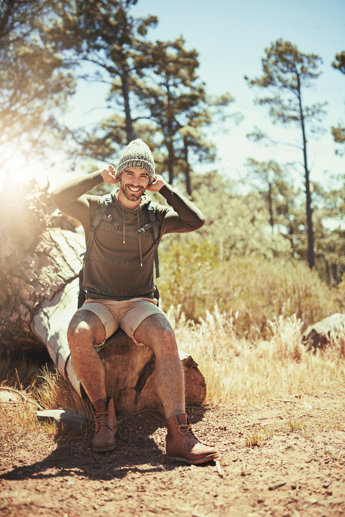 Buy stock photo Full length portrait of a young man taking a break while hiking