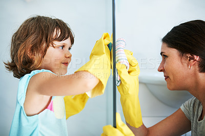 Buy stock photo Shot of a mother and daughter doing chores together at home