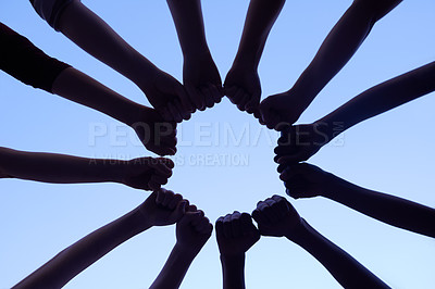 Buy stock photo Hands, teamwork and collaboration for community and support with silhouette on sky backdrop. Group of people and fist, together for team, unity and solidarity in workforce with blue background