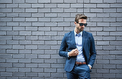 Buy stock photo Fashion, wall and man with sunglasses for confidence, trendy style and professional clothes. Male person, eyewear and lawyer with space by grey background for elegance, classy outfit and suit