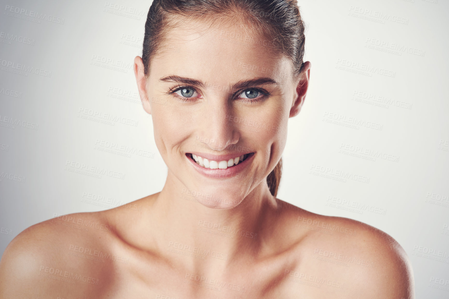 Buy stock photo Studio shot of a beautiful young woman posing against a gray background 