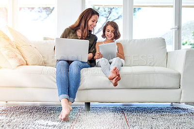 Buy stock photo Shot of a young mother and her daughter at home