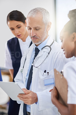Buy stock photo Hospital, tablet and teamwork in a hospital with a mature manager with healthcare workers with tech. Clinic, cardiology research and digital report with conversation and collaboration with discussion