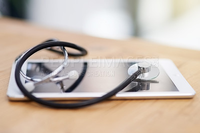 Buy stock photo Cropped shot of a stethoscope on a tablet