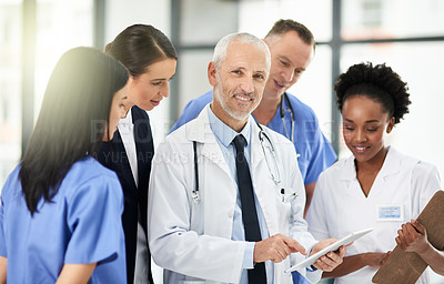 Buy stock photo Senior doctor, team or group with tablet, smile and portrait for leadership, discussion or planning together in hospital. Medic man, mentor and medical student with teamwork, women and healthcare job