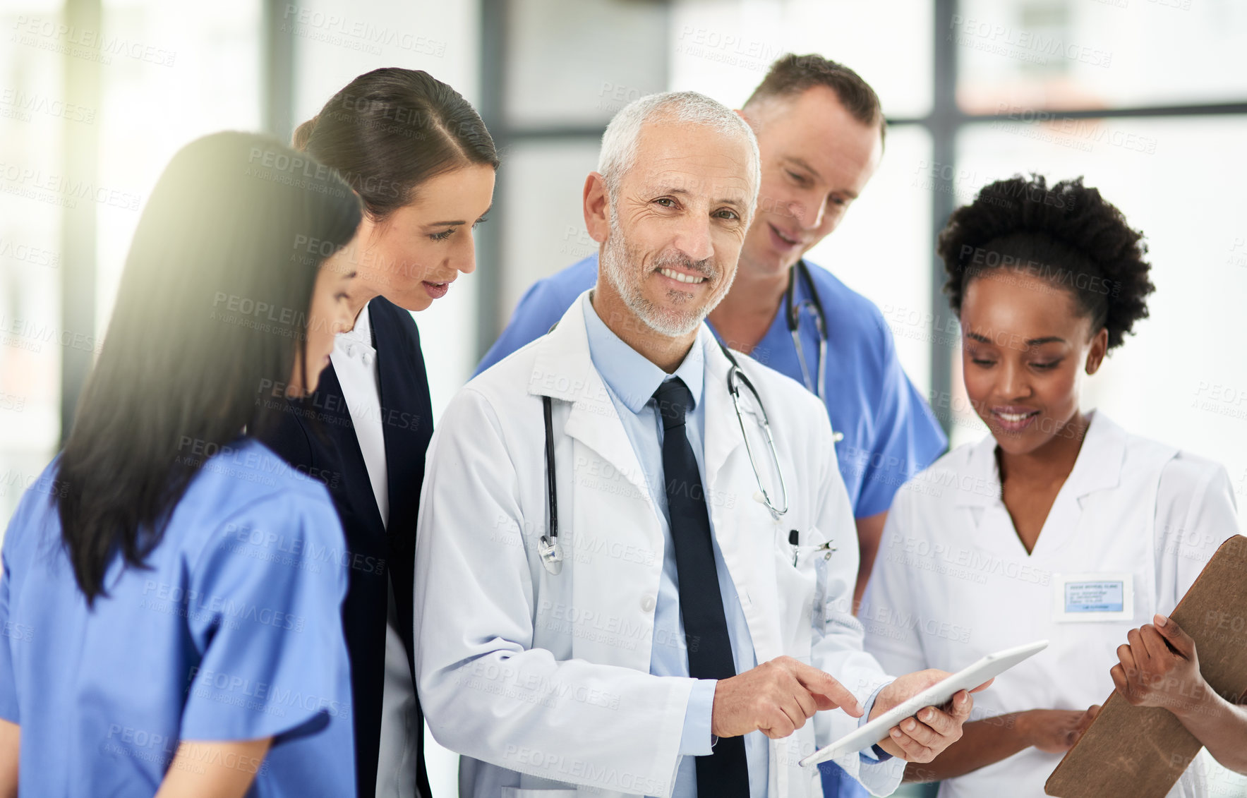 Buy stock photo Senior doctor, team or group with tablet, smile and portrait for leadership, discussion or planning together in hospital. Medic man, mentor and medical student with teamwork, women and healthcare job