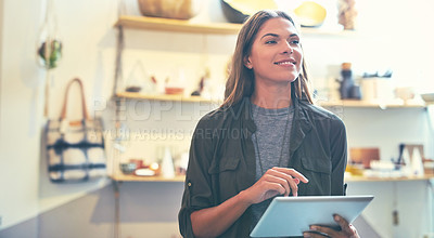 Buy stock photo Shot of a young woman using a tablet indoors 