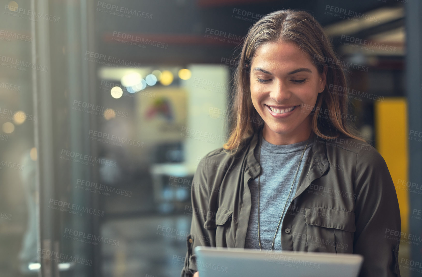 Buy stock photo Shot of a young woman using a tablet indoors 