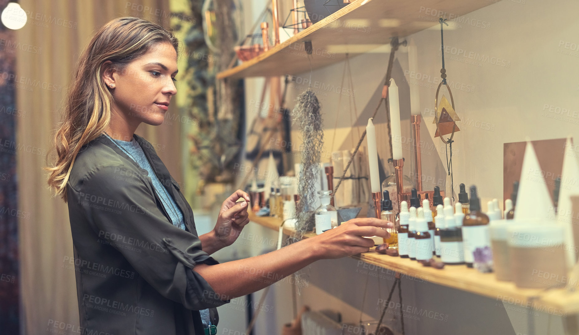 Buy stock photo Woman, consumer and organic product as shop for shopping, skincare and wellness. Female person, customer and serious at shelf for cream, ointment oil and jar with cosmetics, self care and checking