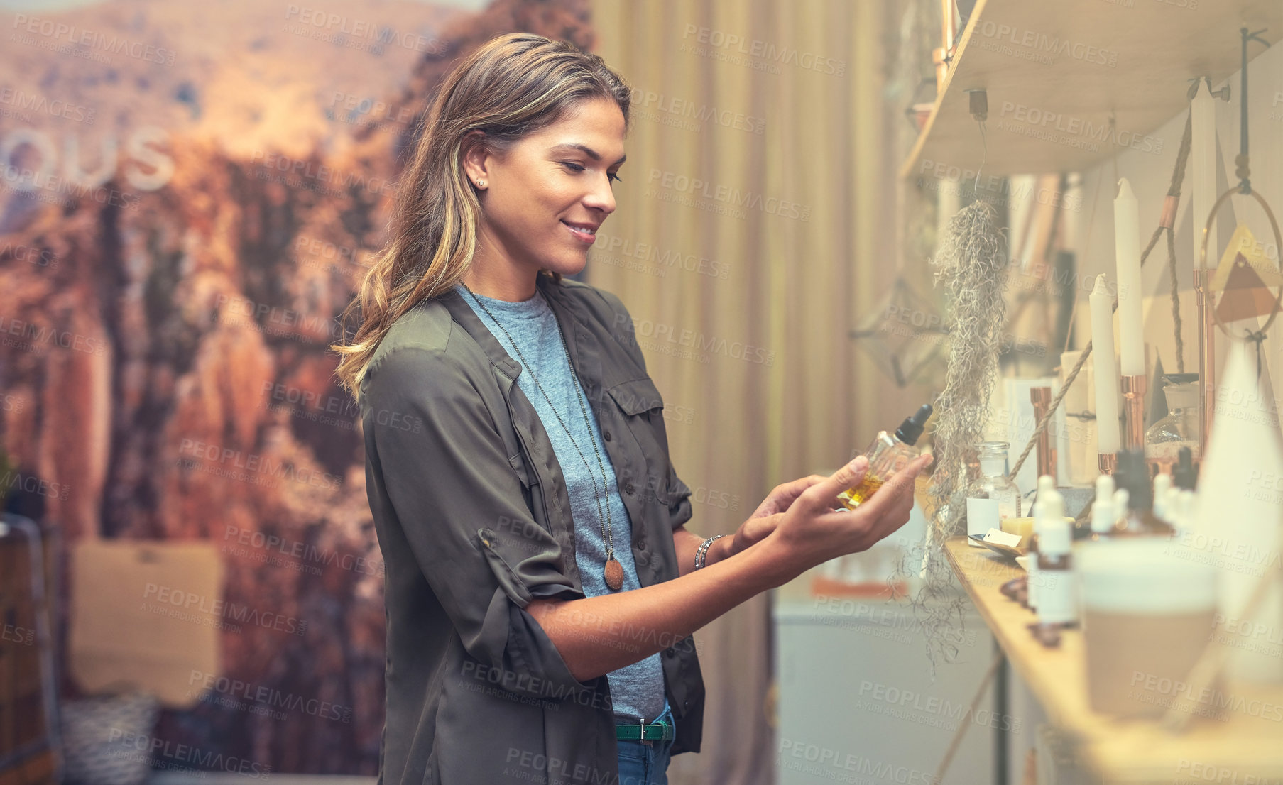 Buy stock photo Shot of a young woman looking at products in a store