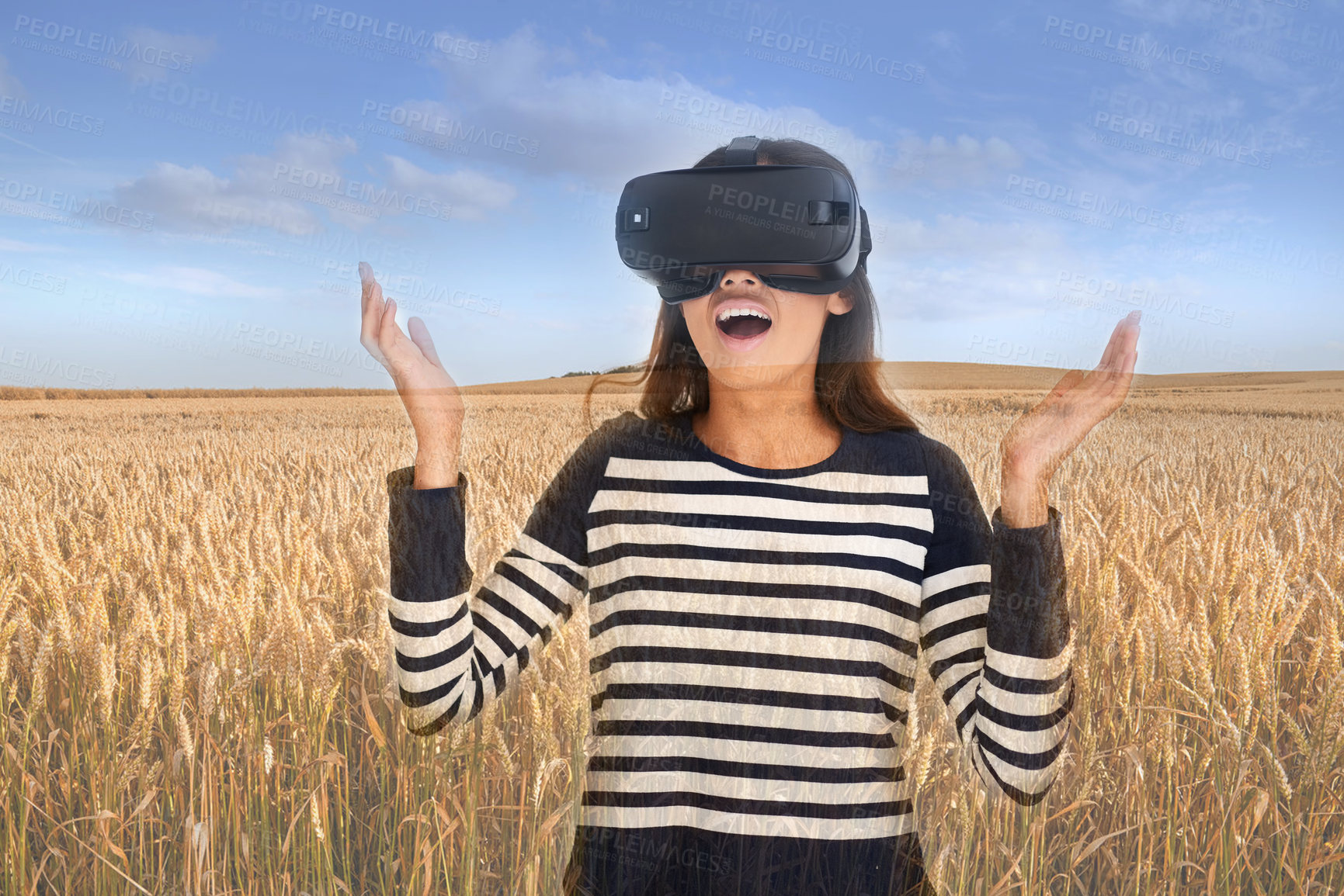 Buy stock photo Shot of a young woman wearing a VR headset superimposed over a wheat field landscape