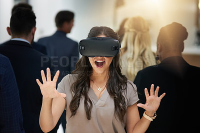 Buy stock photo Shot of a young businesswoman wearing a VR headset in a busy office