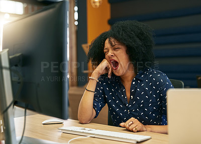 Buy stock photo Shot of a young female designer yawning in her office