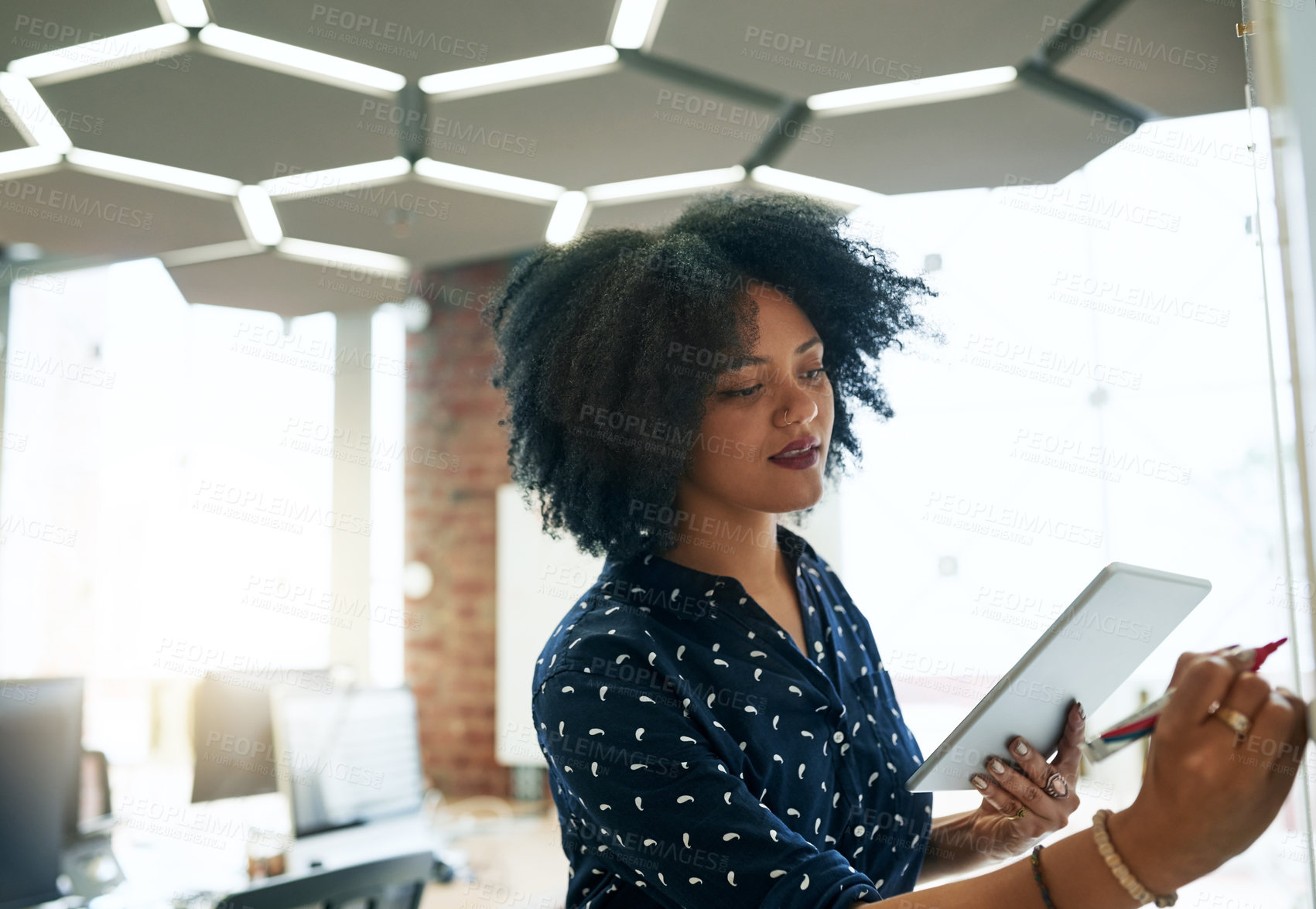 Buy stock photo Shot of a young female designer working in her office