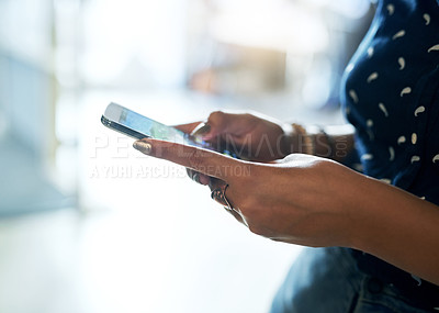 Buy stock photo Shot of an unrecognizable woman using a smartphone in the office