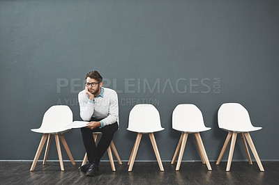 Buy stock photo Shot of a young man waiting in line for a job interview