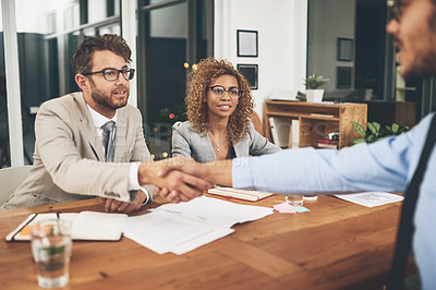 Buy stock photo Shot of businesspeople shaking hands during a job interview in an office