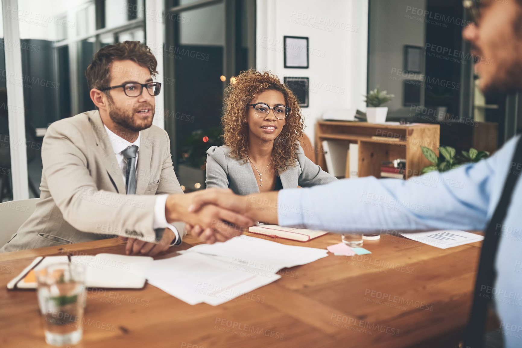 Buy stock photo Shot of businesspeople shaking hands during a job interview in an office