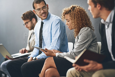 Buy stock photo Shot of a group of businesspeople waiting in line for a job interview