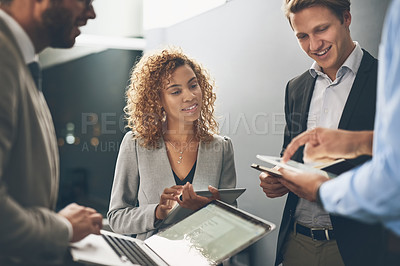 Buy stock photo Shot of a group of businesspeople using digital devices while brainstorming in an office