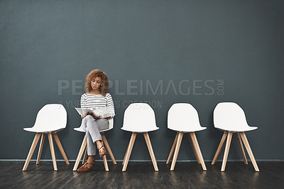 Buy stock photo Shot of a young woman waiting in line for a job interview