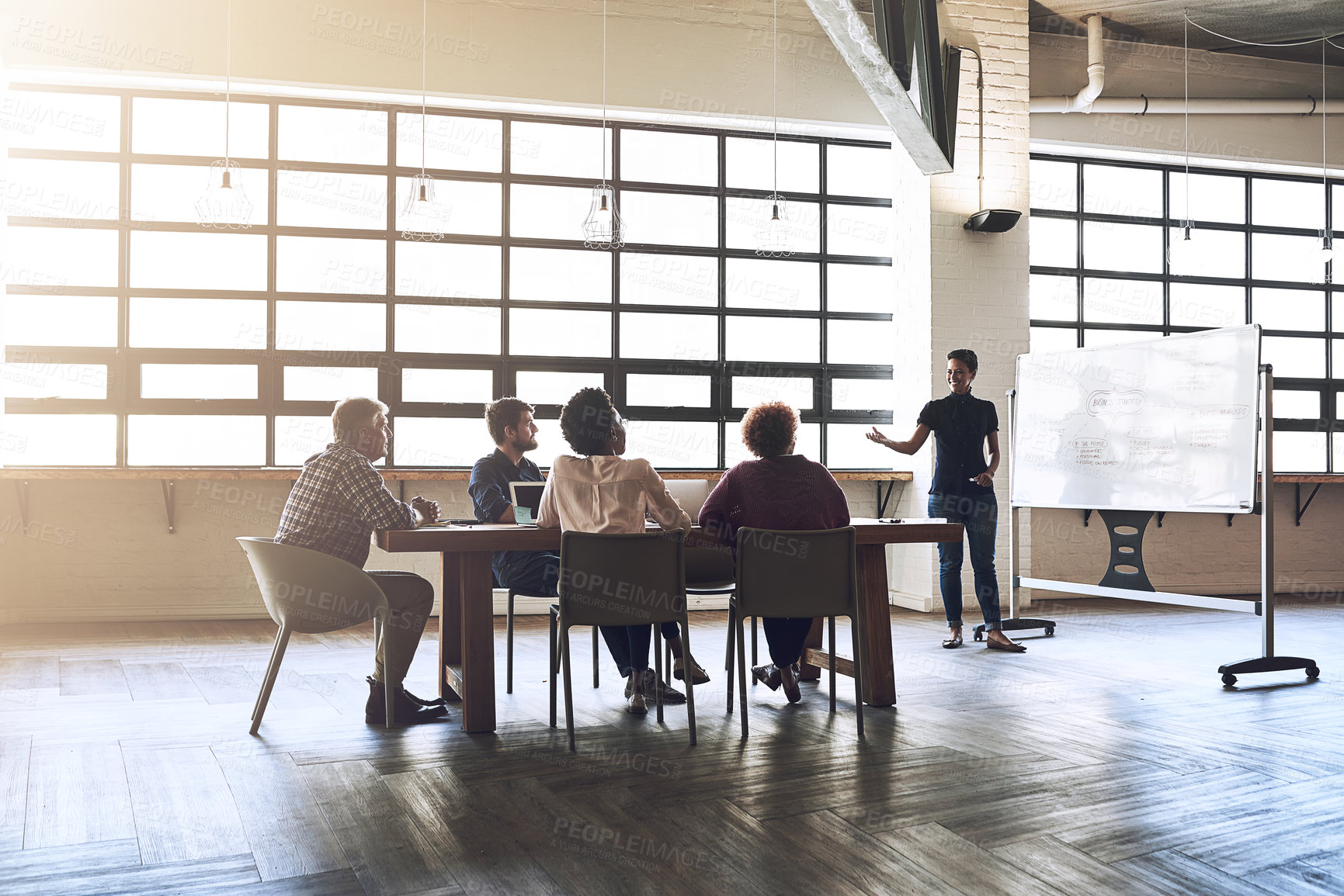Buy stock photo Shot of a group of colleagues having an office meeting inside