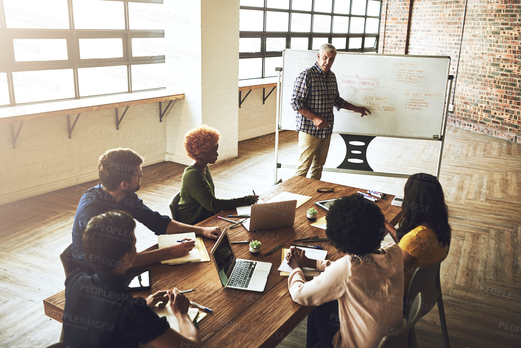 Buy stock photo Shot of a group of colleagues having an office meeting inside