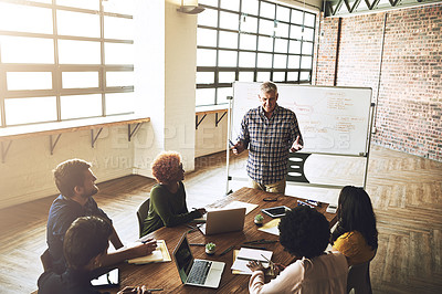 Buy stock photo Boardroom, business people and man with whiteboard for presentation, feedback and performance update. Marketing agency, ceo and employees in meeting for training, listening or company progress review