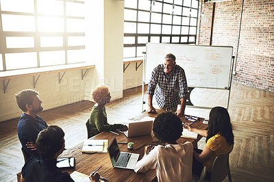 Buy stock photo Shot of a group of colleagues having an office meeting inside