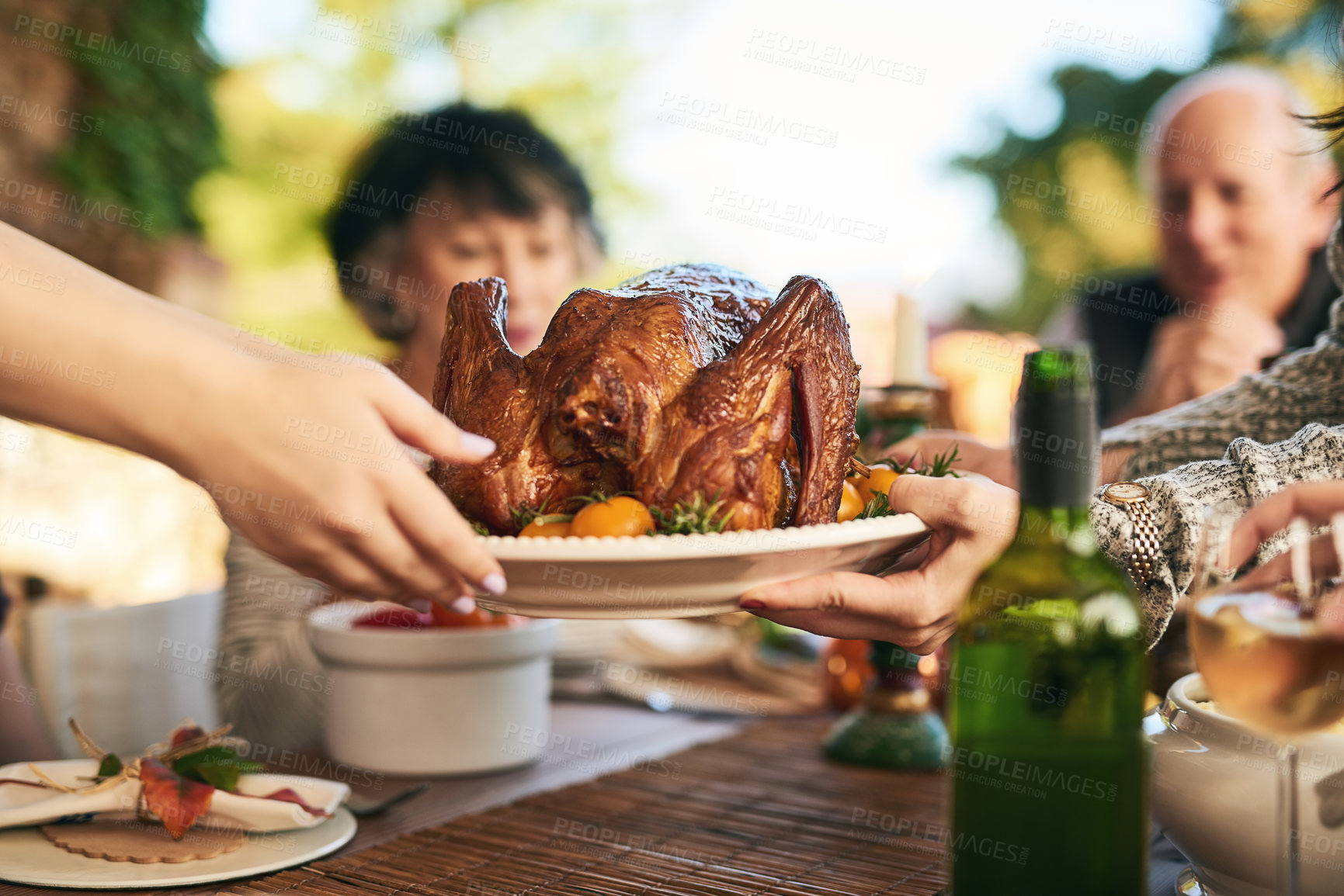 Buy stock photo Thanksgiving, turkey and hands with a family eating a meal outdoor together in celebration of tradition. Christmas, chicken and party with a man and woman group enjoying dinner while bonding
