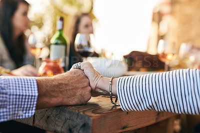 Buy stock photo Hands, pray and party with a senior couple sitting at a dinner day with their family for a celebration. Holding hands, love and prayer with a mature man and woman enjoying a meal together in a home