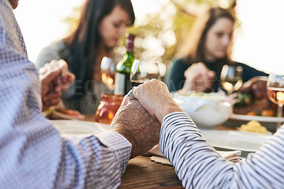 Buy stock photo Family, prayer and lunch for thanksgiving, celebration or party in garden, backyard or outdoor restaurant. Holding hands, mindfulness and gratitude for worship, god and praying with food on table