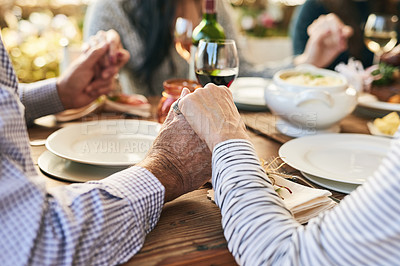 Buy stock photo Dinner, holding hands and family prayer at table for thanksgiving celebration with faith, religion and holiday gratitude. Love, social and hand holding of people praying for party, food and wine