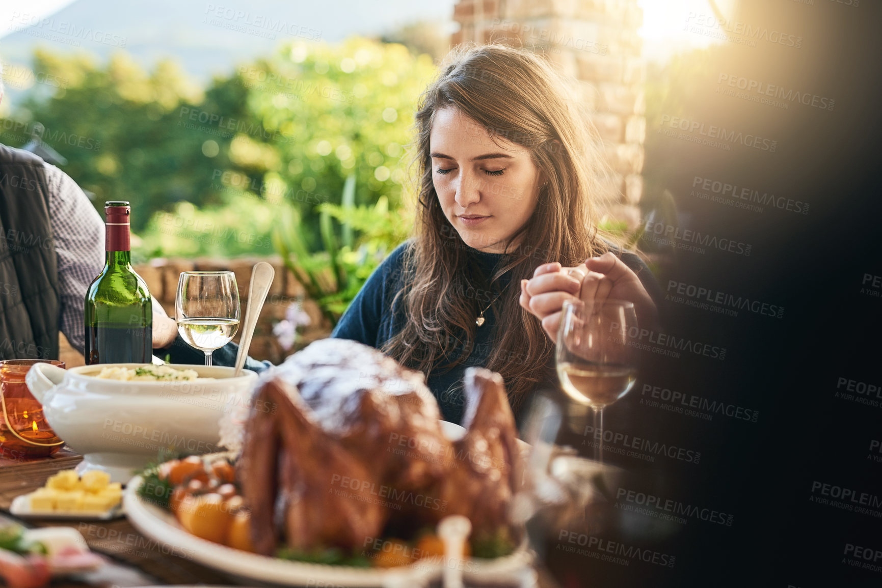 Buy stock photo Family, food and prayer at table, hand holding and praying before sharing meal on patio, blessing and gratitude. Pray, hands and woman in thanksgiving grace before eating lunch with friends outdoor